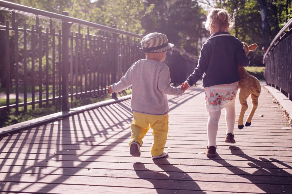 Children On A Bridge 2 children running across a wooden bridge.